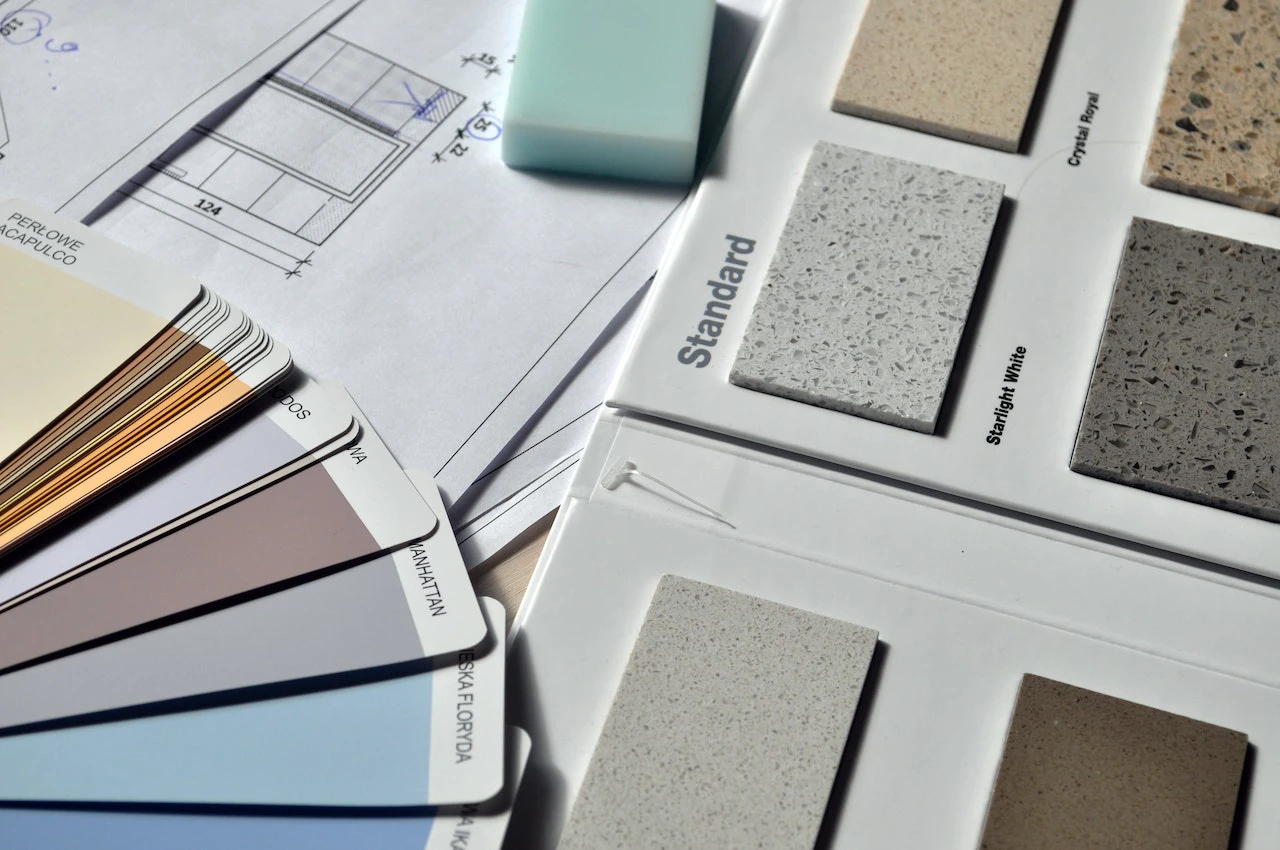 A selection of tile and paint swatches alongside a property floorplan