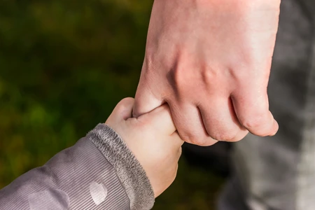 child holding hand of parent