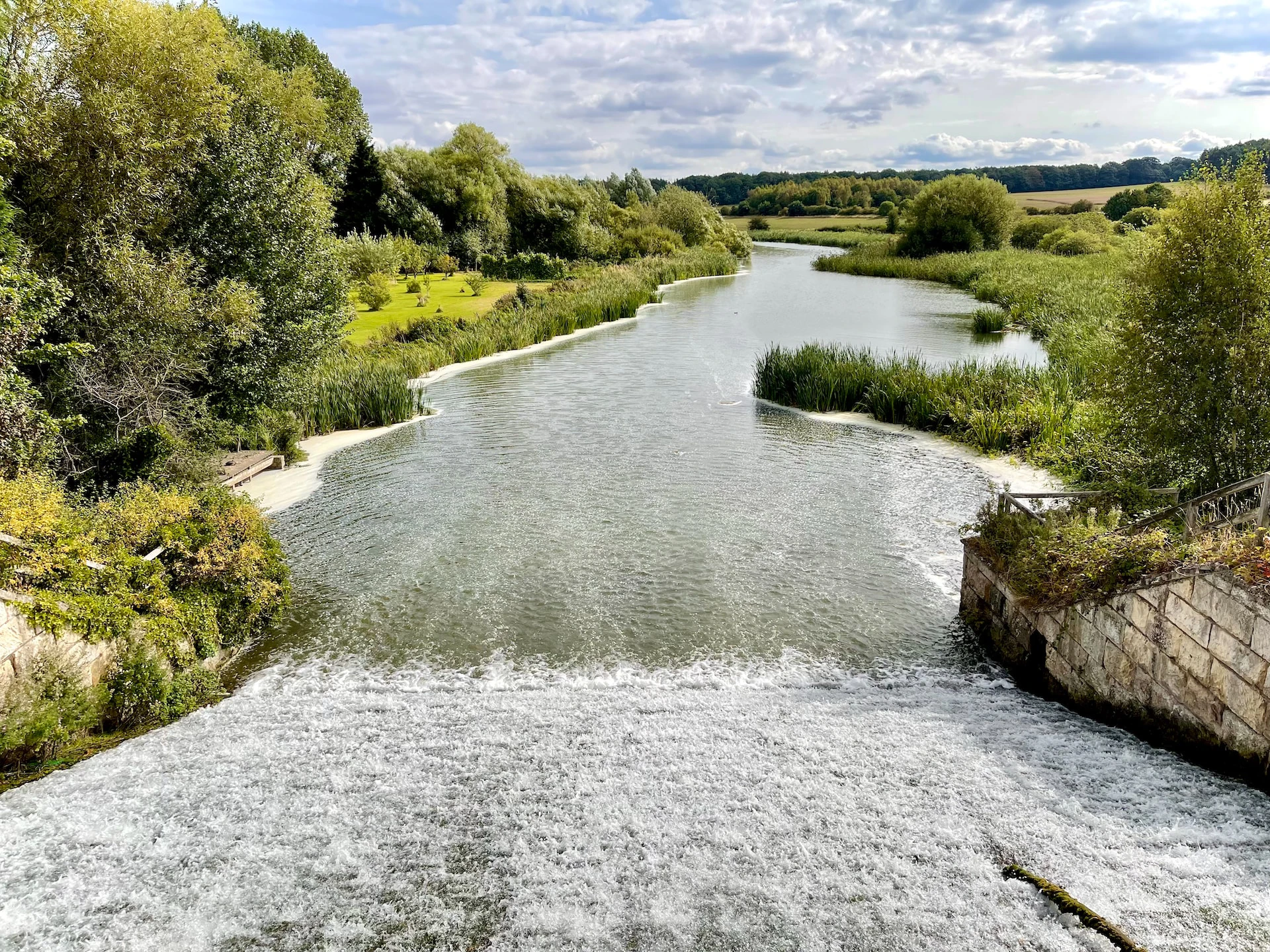 a river running through a lush green countryside