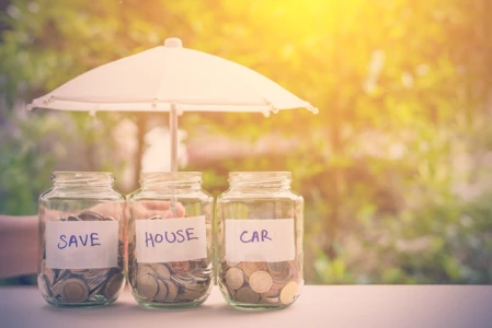 Jars of money set aside for saving - to be used to pay off mortgage early