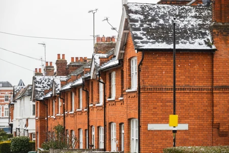 english terraced houses with snow on the rooftops