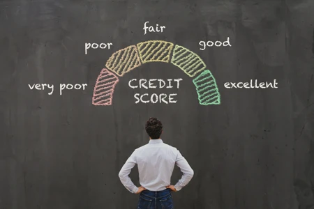 man looking at credit score graph on blackboard