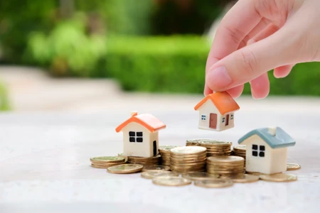 Pick up House model over coin stacks