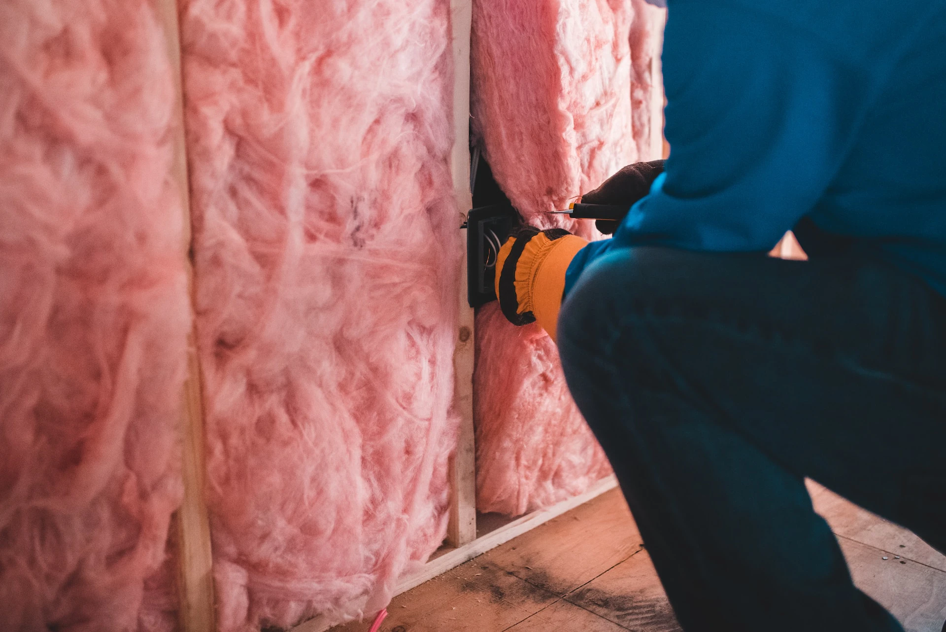 Builder installing insulation into a wall