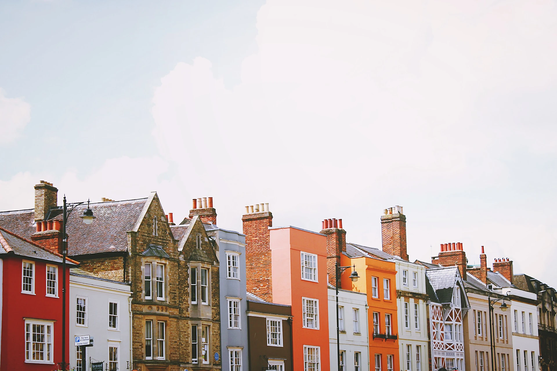 row of brick townhouses from a halfway up view, with blue sky behind them