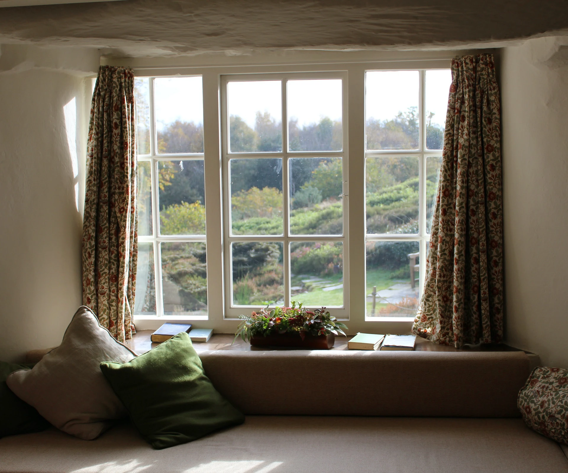 big window framed by light brown curtains