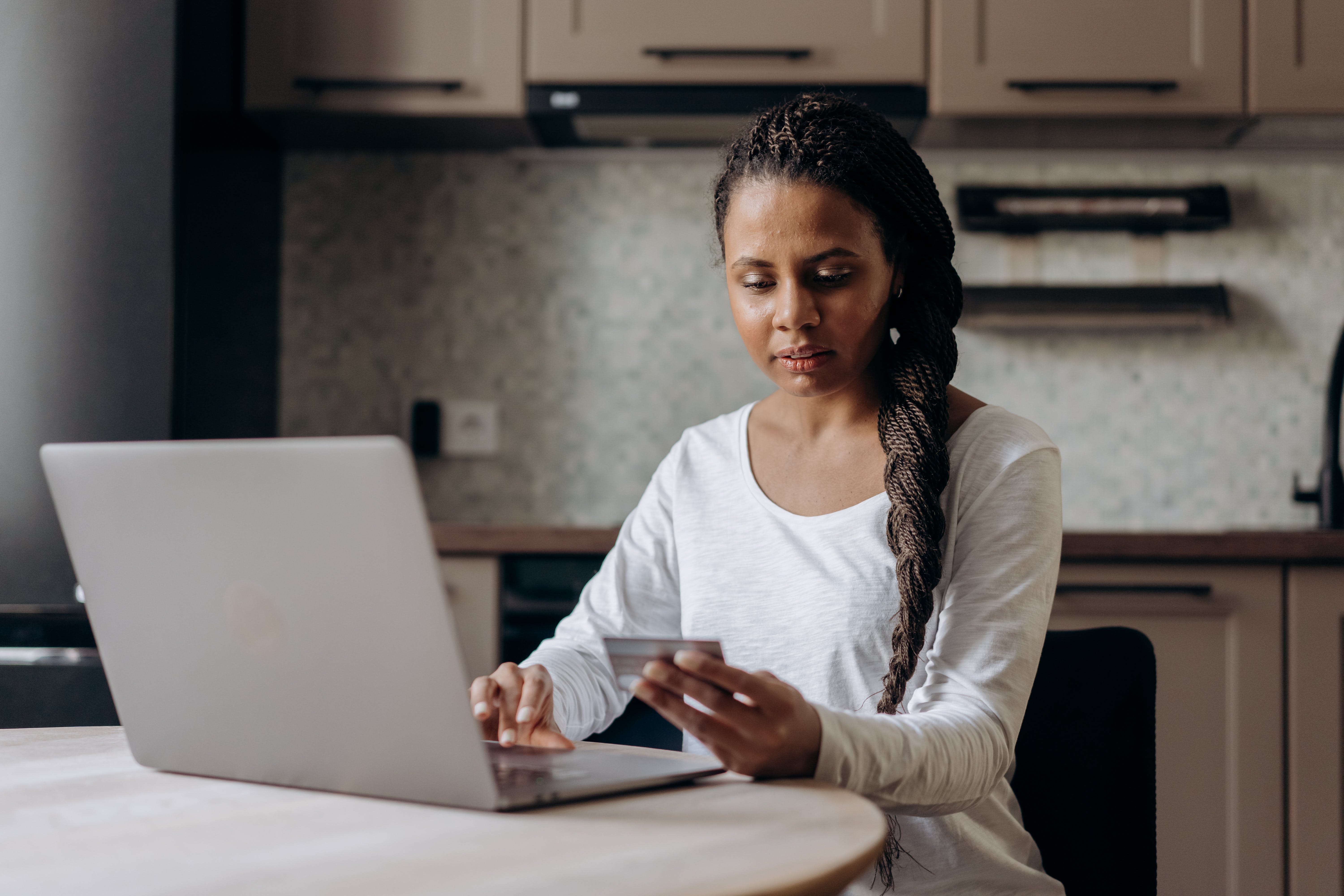 woman on laptop using credit card