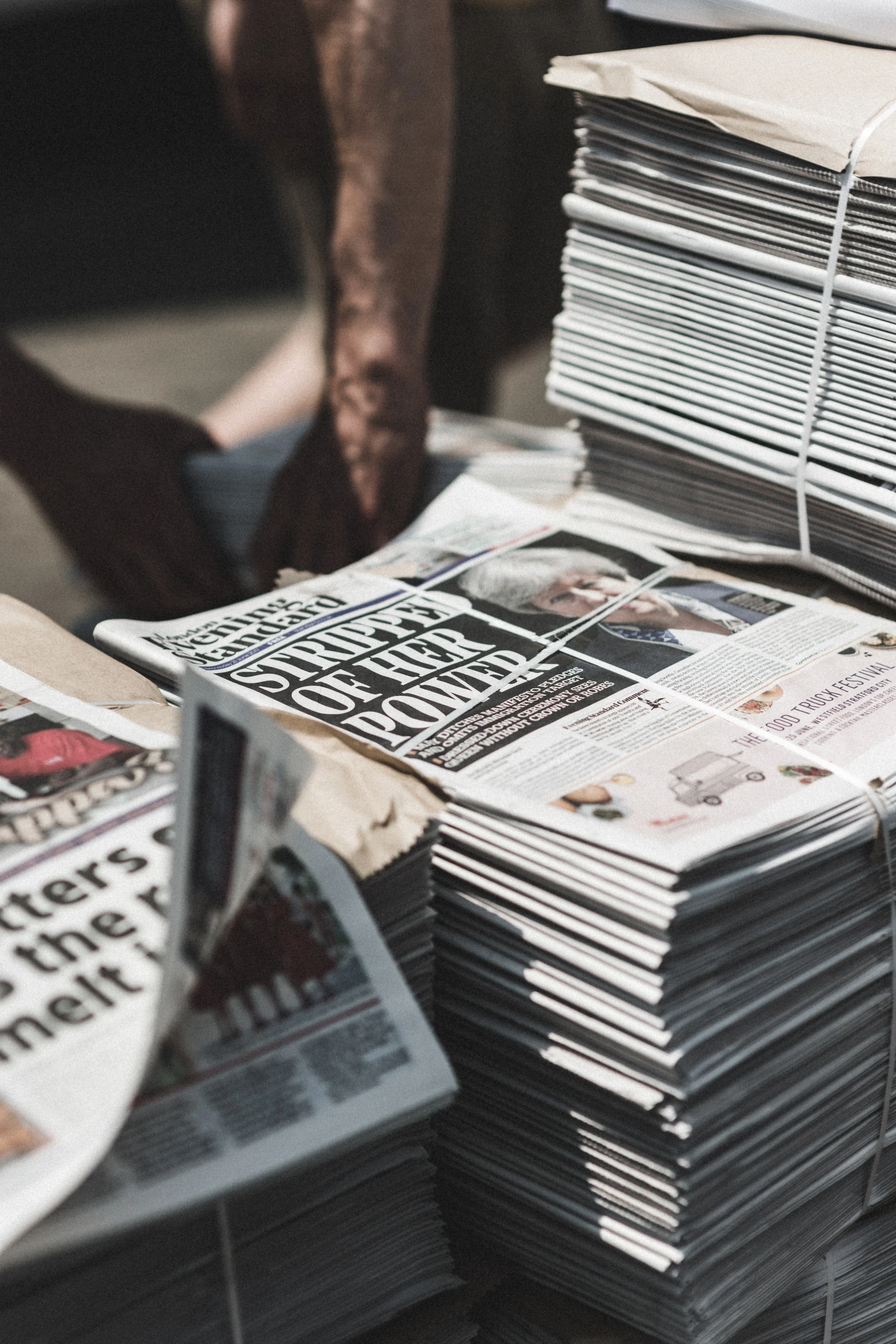 Newspaper stack on street background