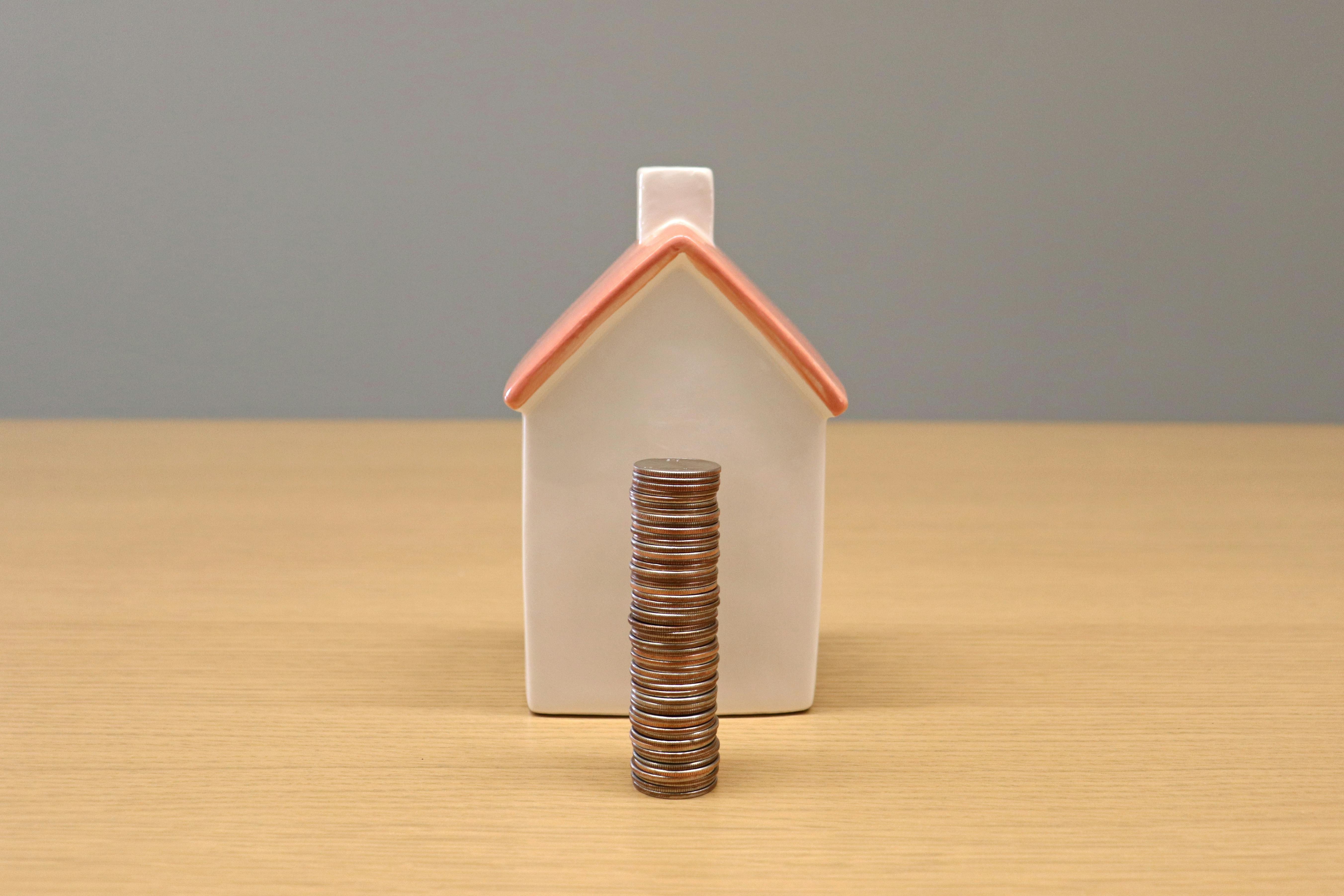 house and coins stacked up in pile