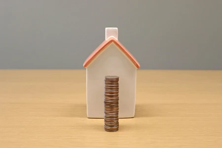 house and coins stacked up in pile