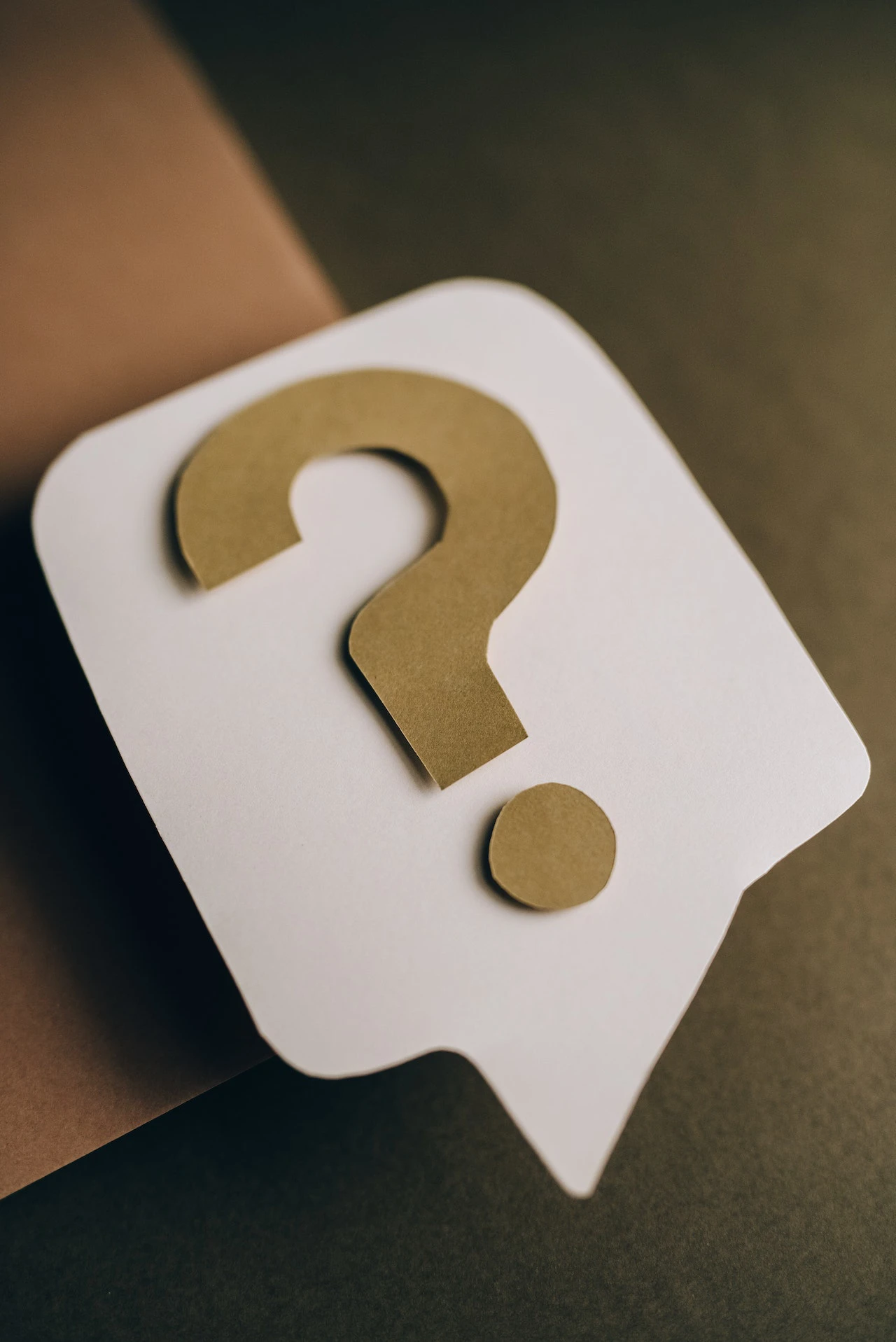 brown kraft paper question mark on white speech bubble cutout