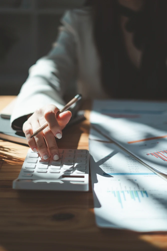 Close up Business woman using calculator