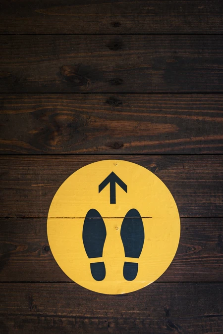 Painted shoes marks in yellow dot on the floor to show where to start when looking at protection