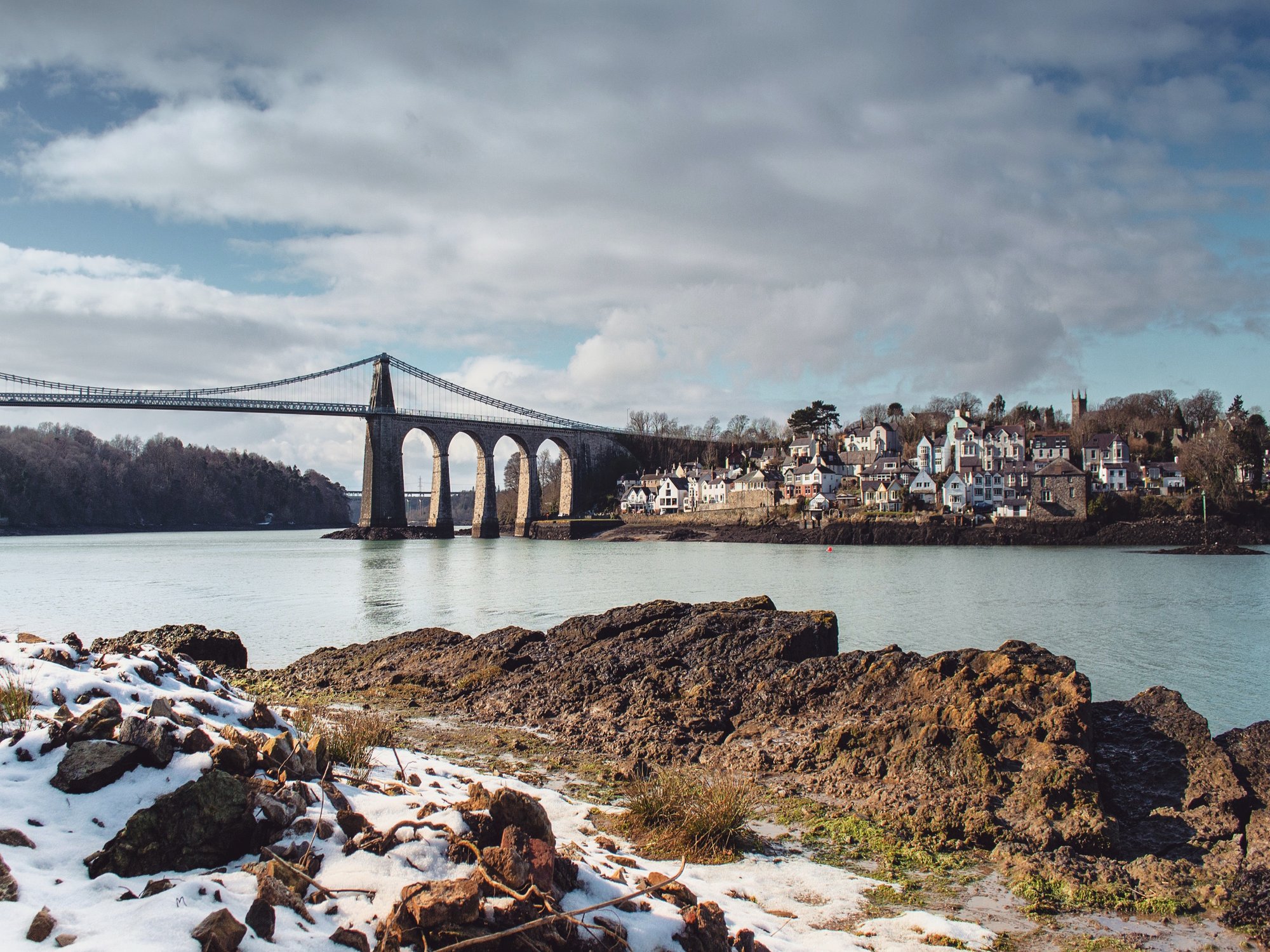A suspension bridge across a large body of water