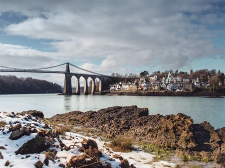 A suspension bridge across a large body of water