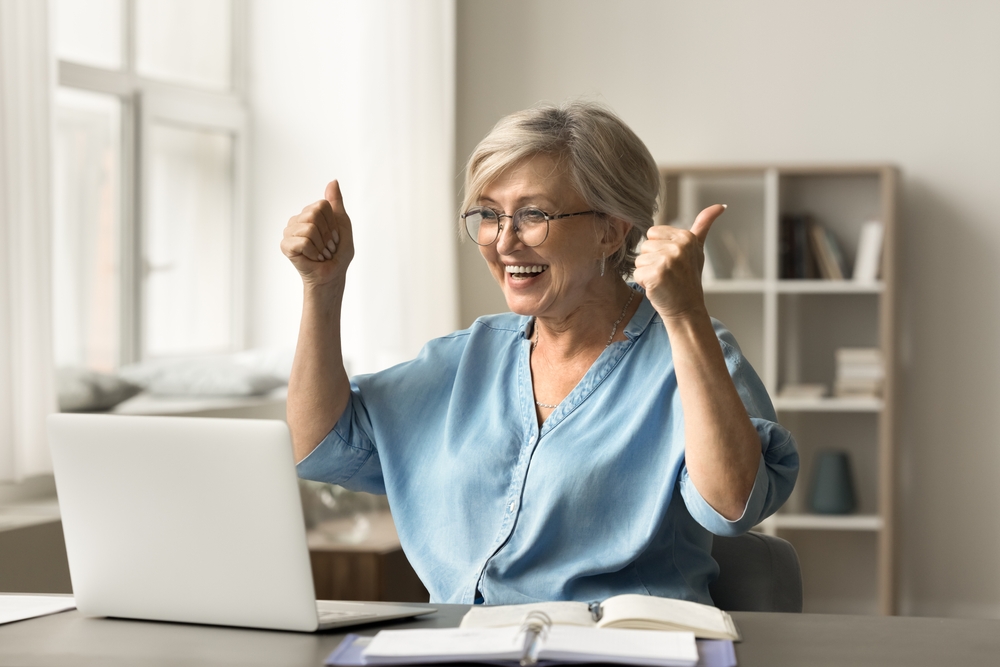 Women on her laptop improving her chance of getting a mortgage in later life. 