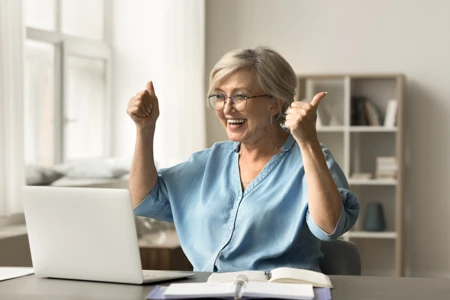 Women on her laptop improving her chance of getting a mortgage in later life.