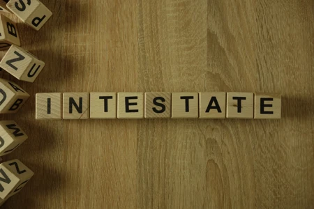 Intestate word spelled from wooden blocks on wooden surface
