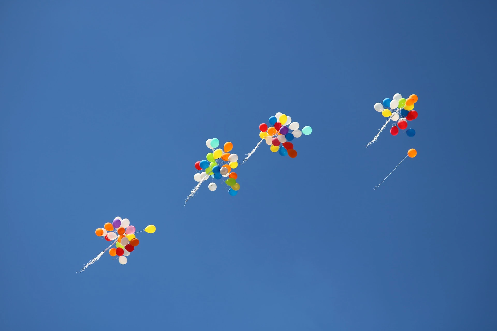 colourful balloons on blue sky background