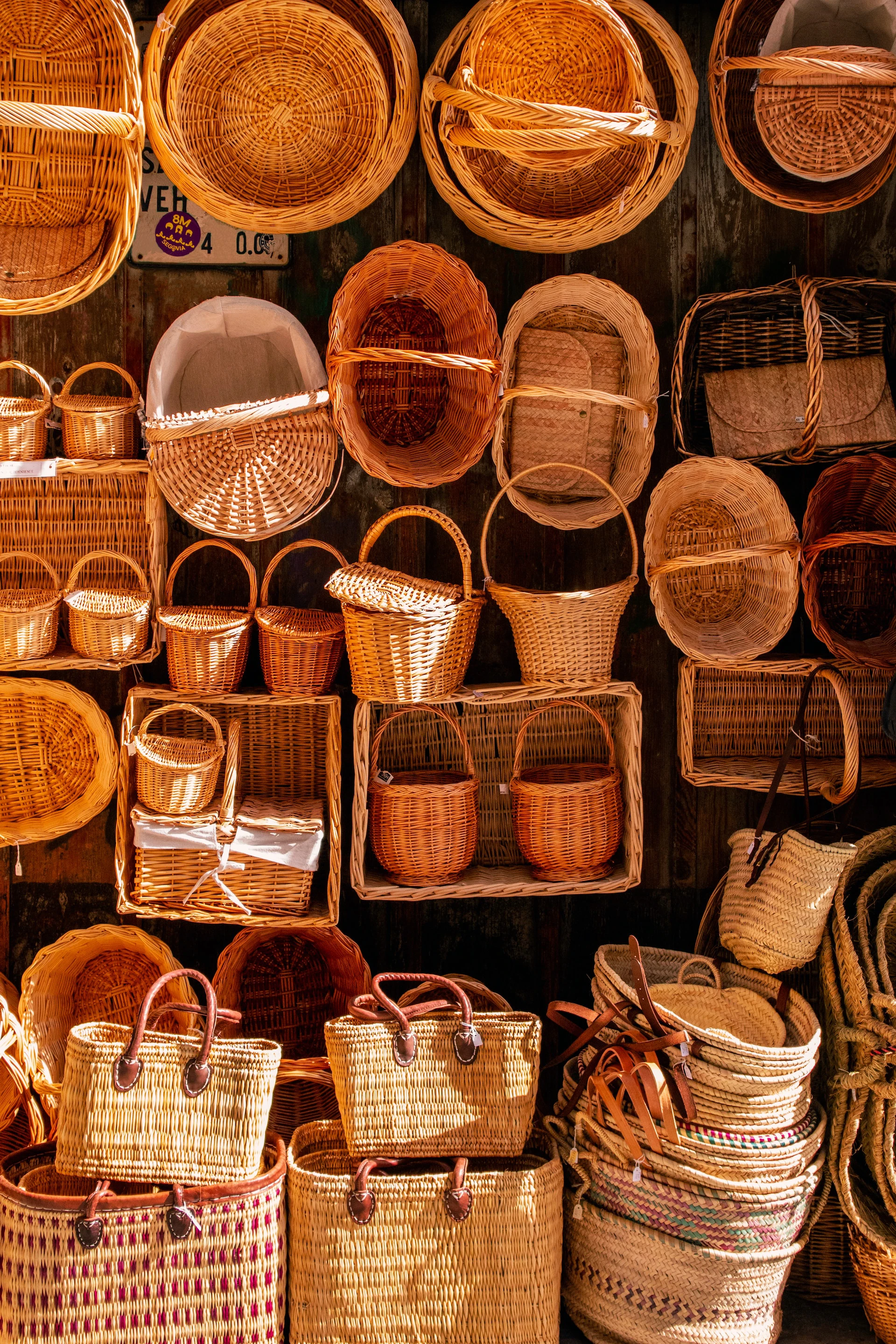 variety of wicker baskets stacked against dark backgroun