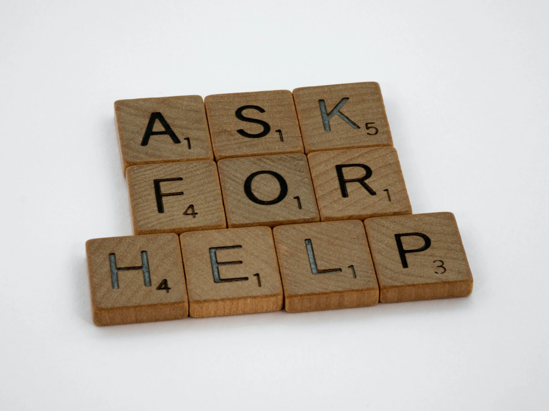 scrabble letters spelling out the words "ask for help"