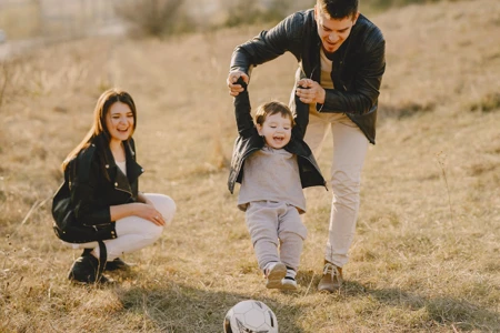 Photo of Family Having Fun With Footall