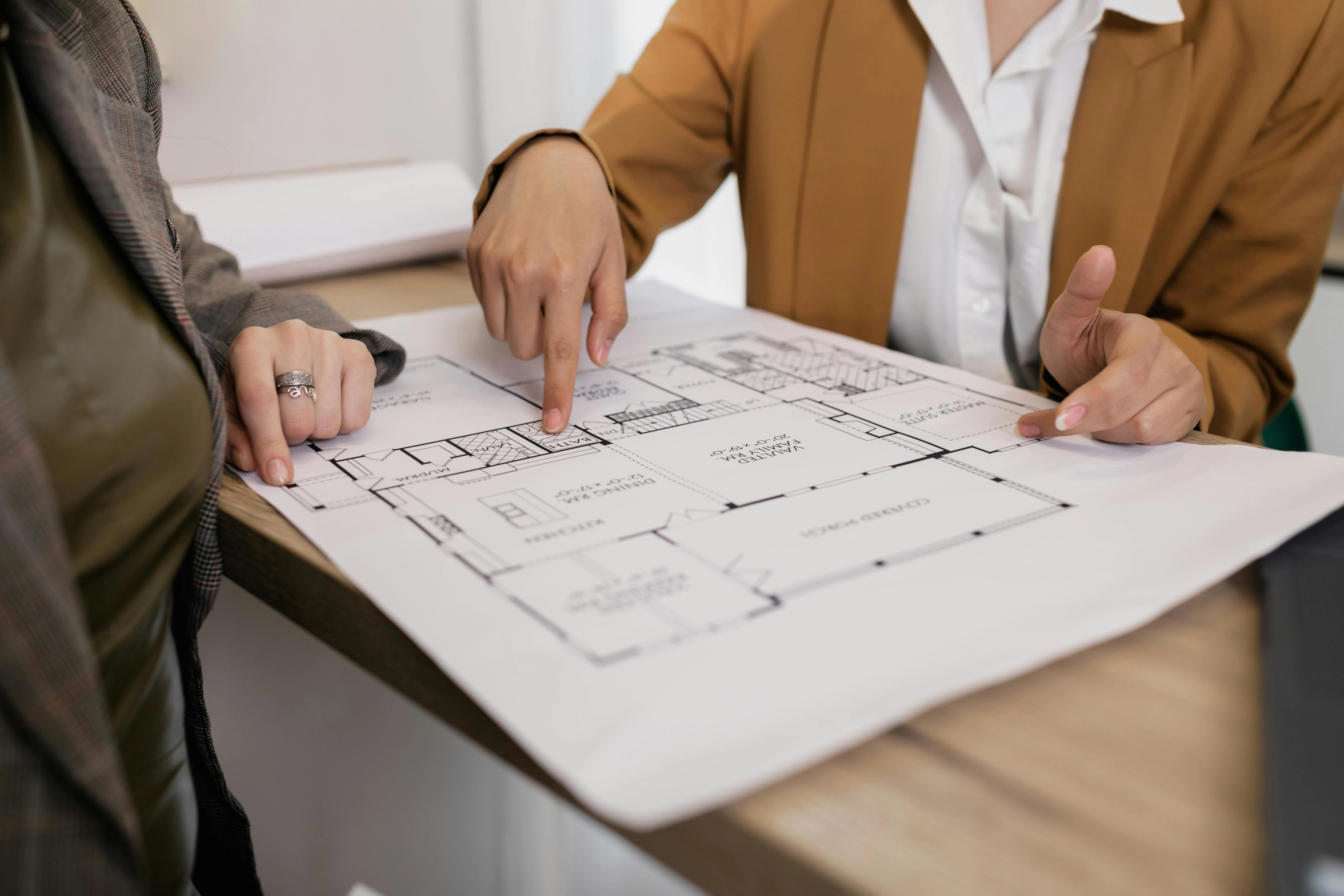 couple examining blueprint plans for new build home