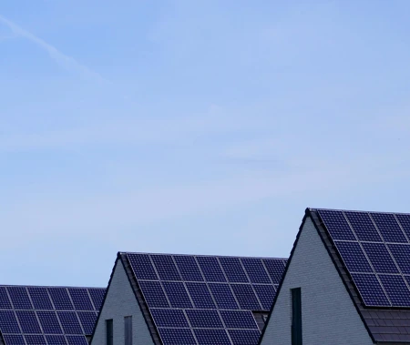 houses with solar panels on roof sky in background