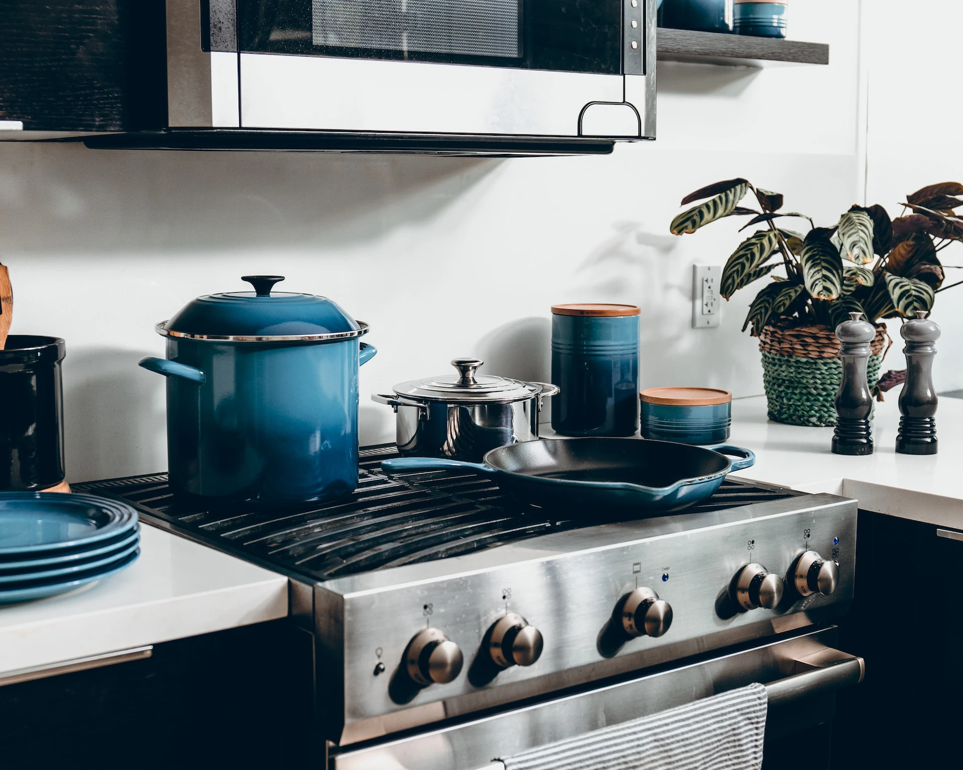 modern kitchen stovetop with pots and pans