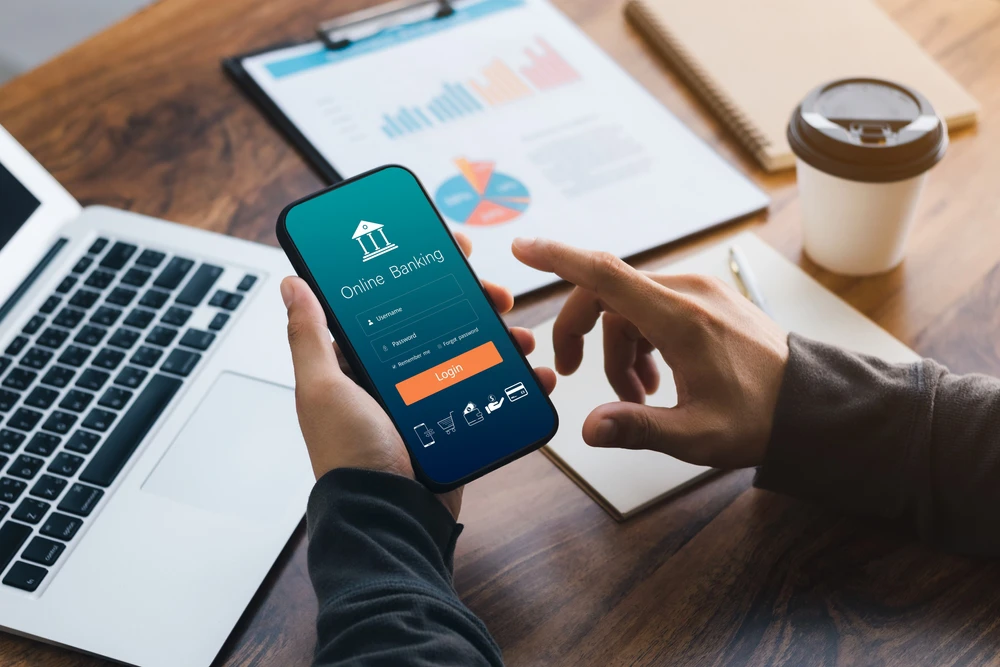 hands holding a cellphone with online banking app open