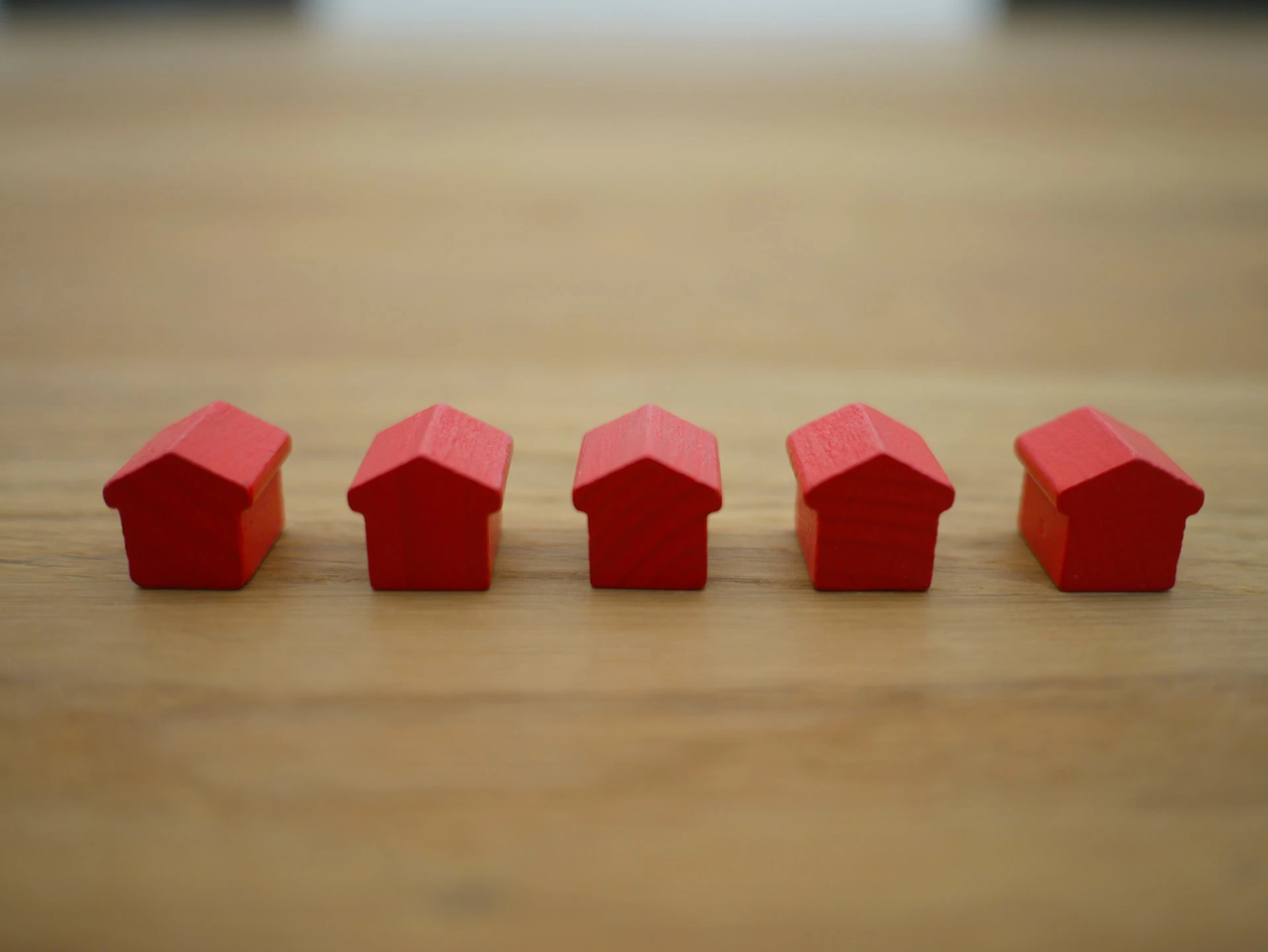 row of mini red houses on a table