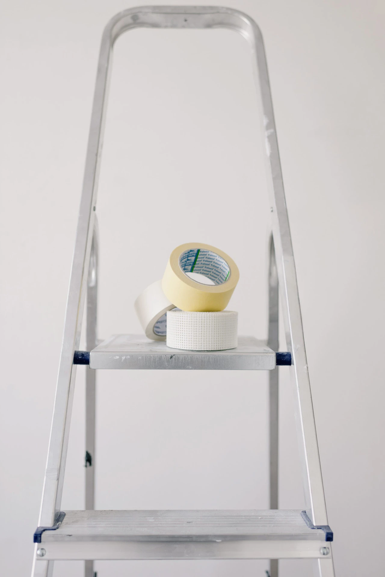 Ladder with three rolls of tape on top