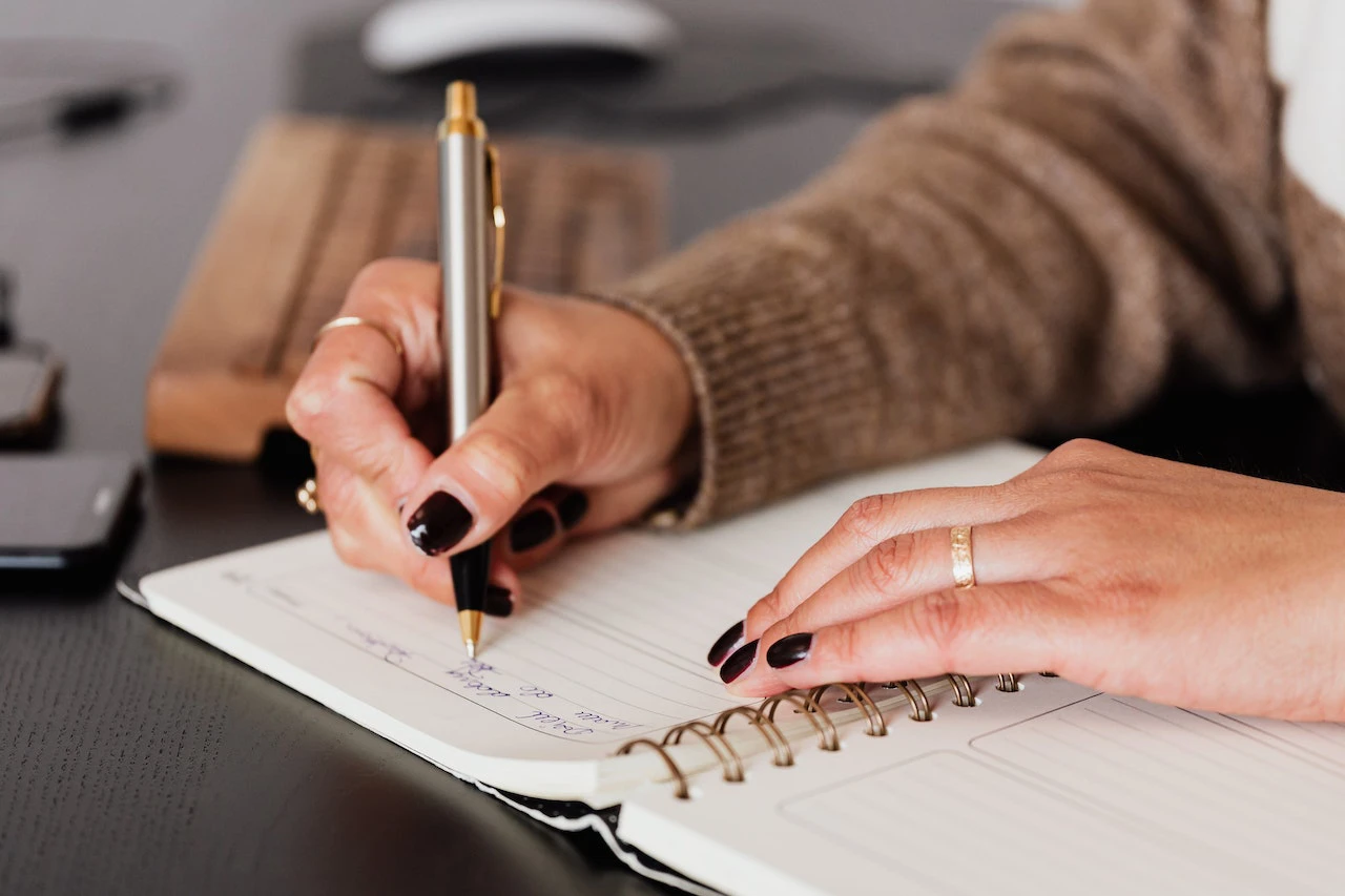 person writing in a notebook