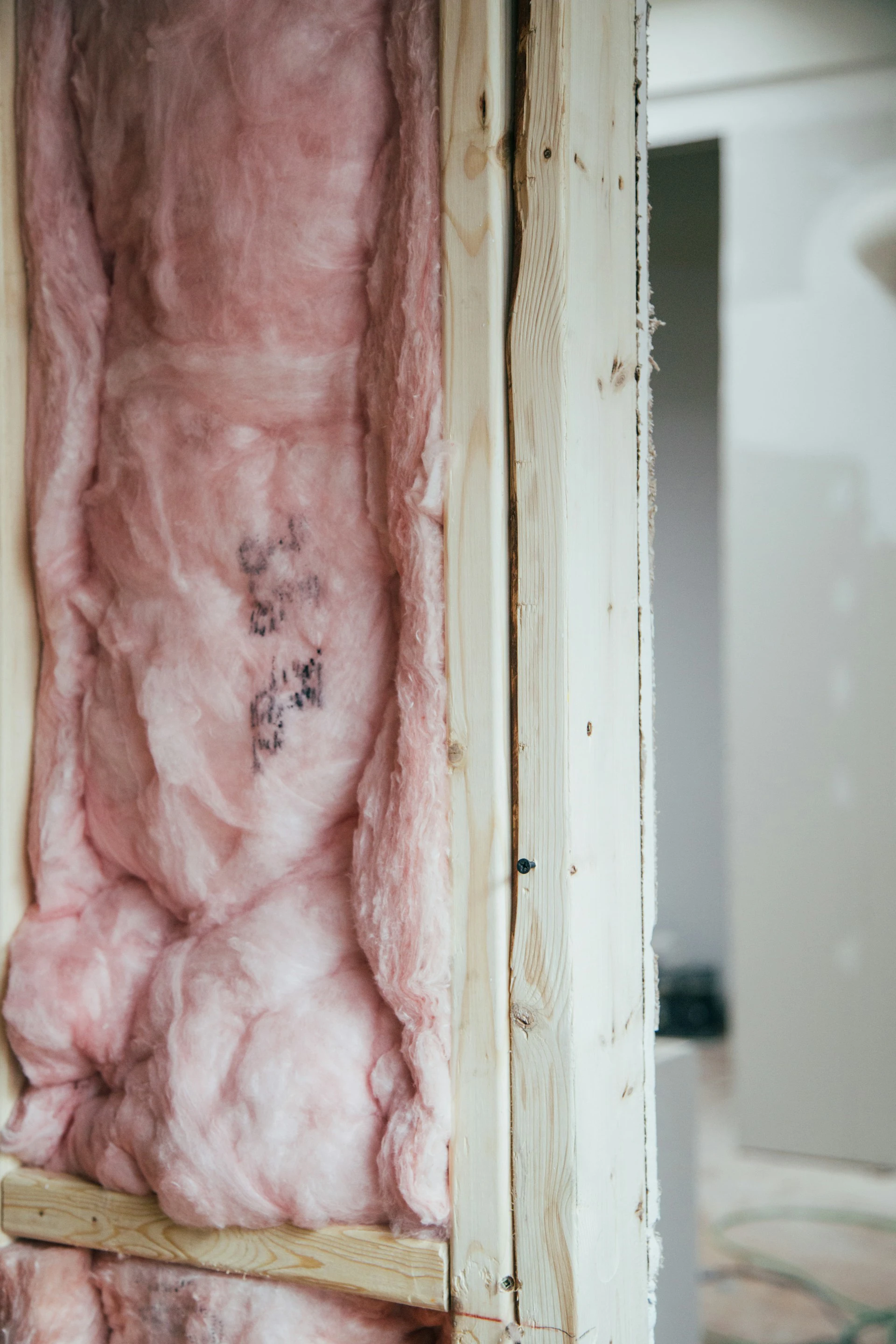 pink insulation in wooden wall beams