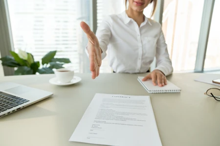Businesswoman employer extends hand for handshake offers to sign contract