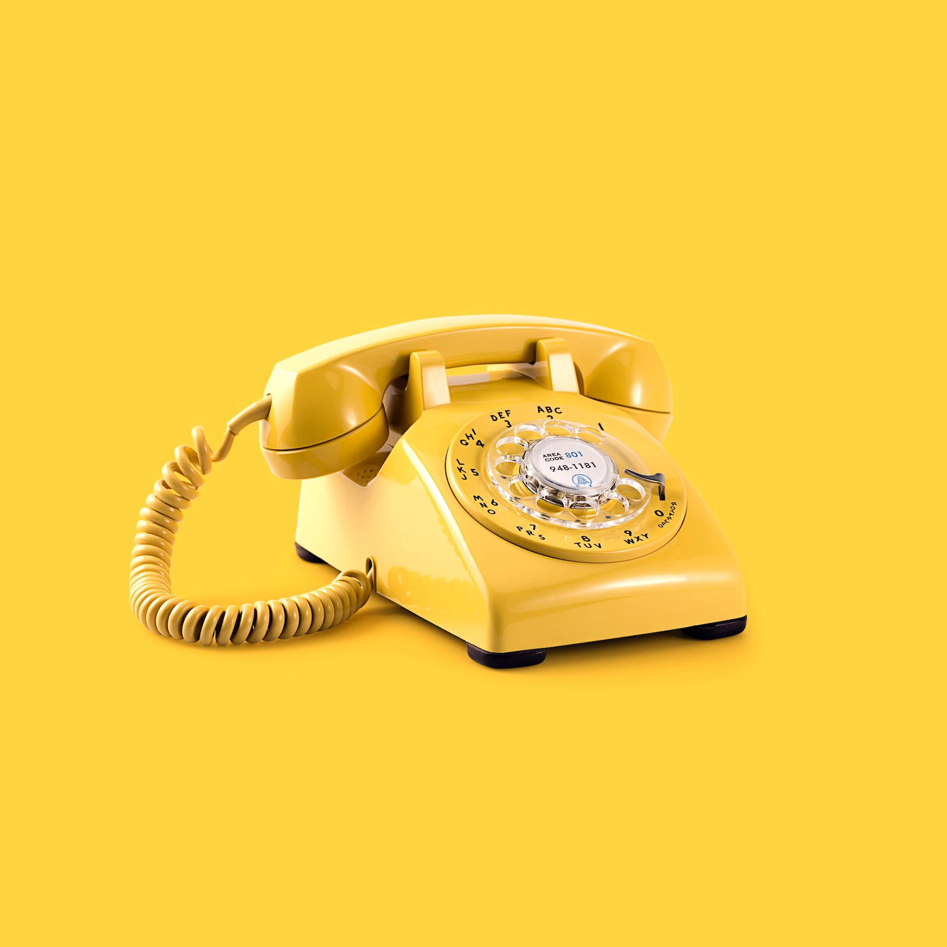 yellow telephone on yellow background