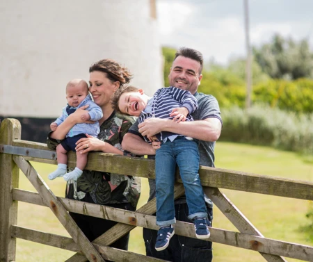 Family walking through a field.